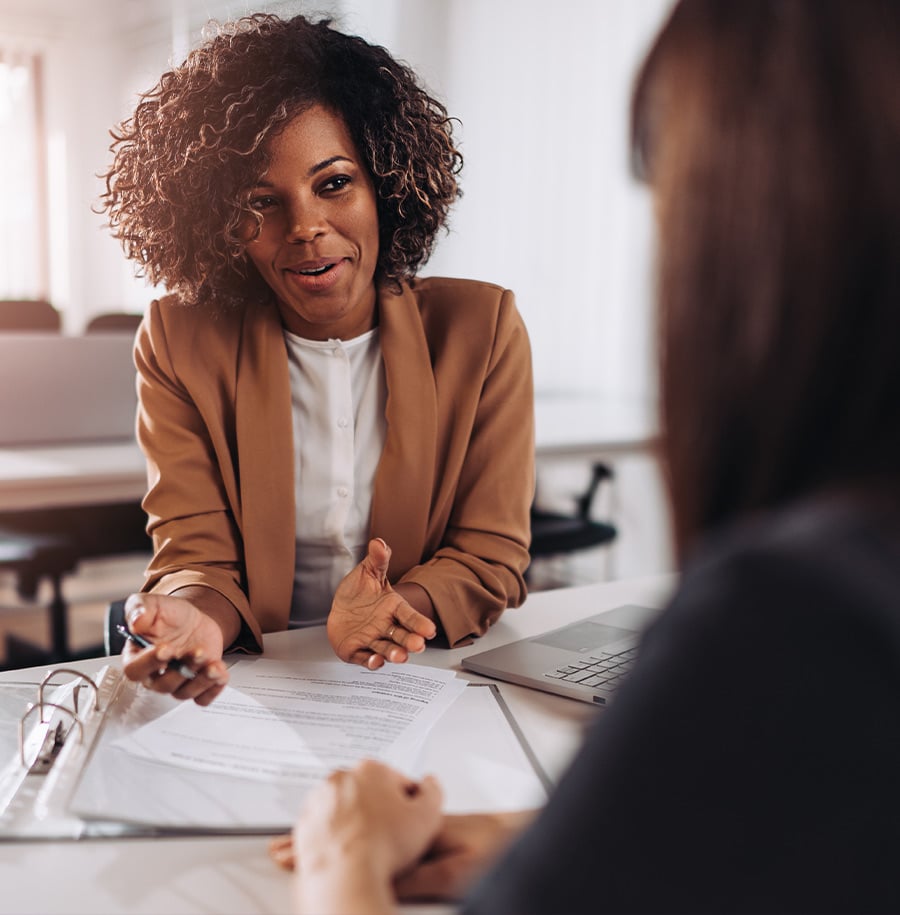 woman consulting person over paperwork